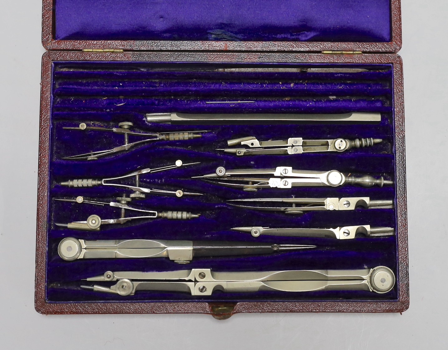 A cased set of draughtsman's instruments and two small telescopes